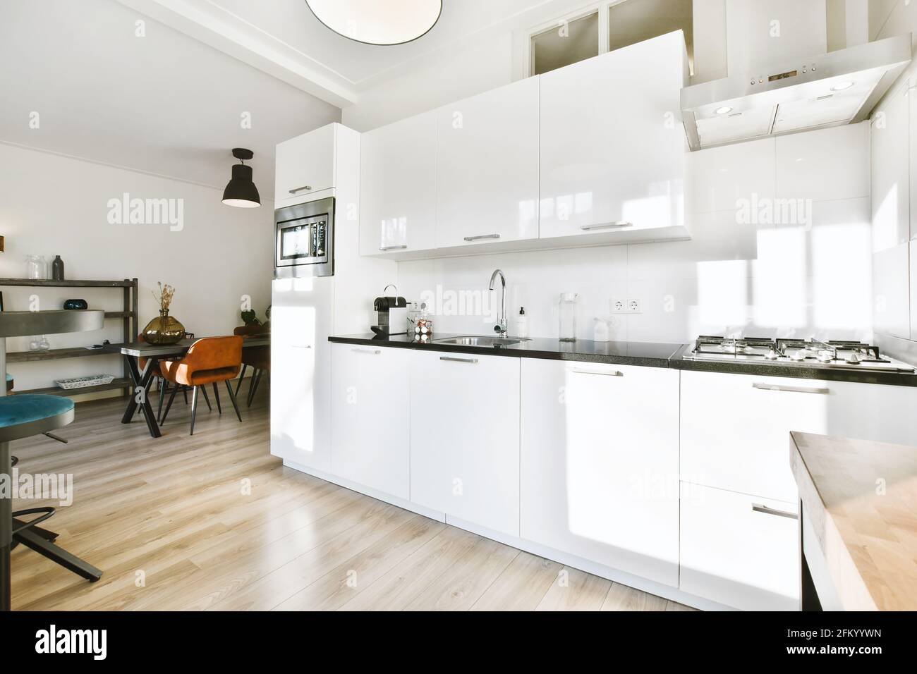 Modern kitchen with white furniture in apartment Stock Photo - Alamy