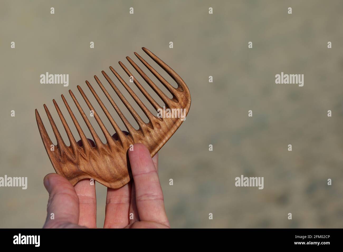 Handmade wooden comb for head massage and hair combing. Hair care