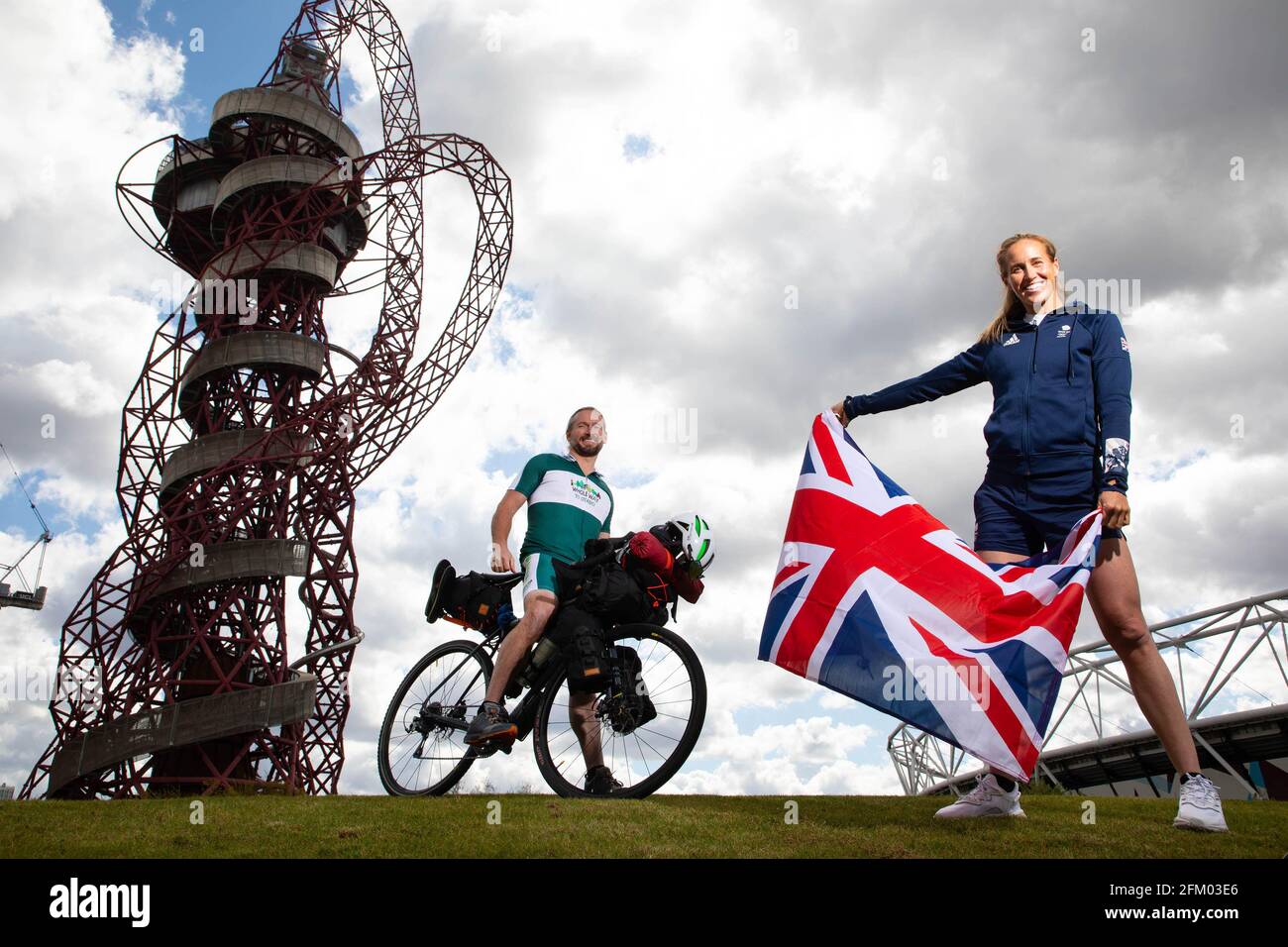 EDITORIAL USE ONLY (Left to right) Team GB fan, Jamie Ramsay is joined by Double Olympic champion Helen Glover MBE as he stARTSs his 80-day 10,000km ???Whole EARTSh - Whole Way to Stokeyo??? solo cycle around the UK to rally the nation???s support ahead of the rescheduled Games, Queen Elizabeth Olympic Park, London. Issue date: Wednesday May 5, 2021. Stock Photo