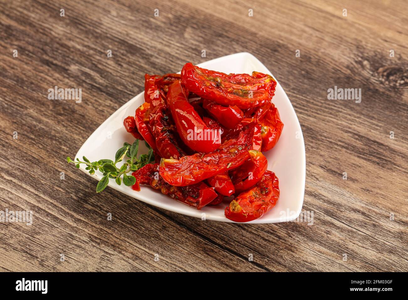 Sundried tomato in olive oil with herbs and spices Stock Photo Alamy