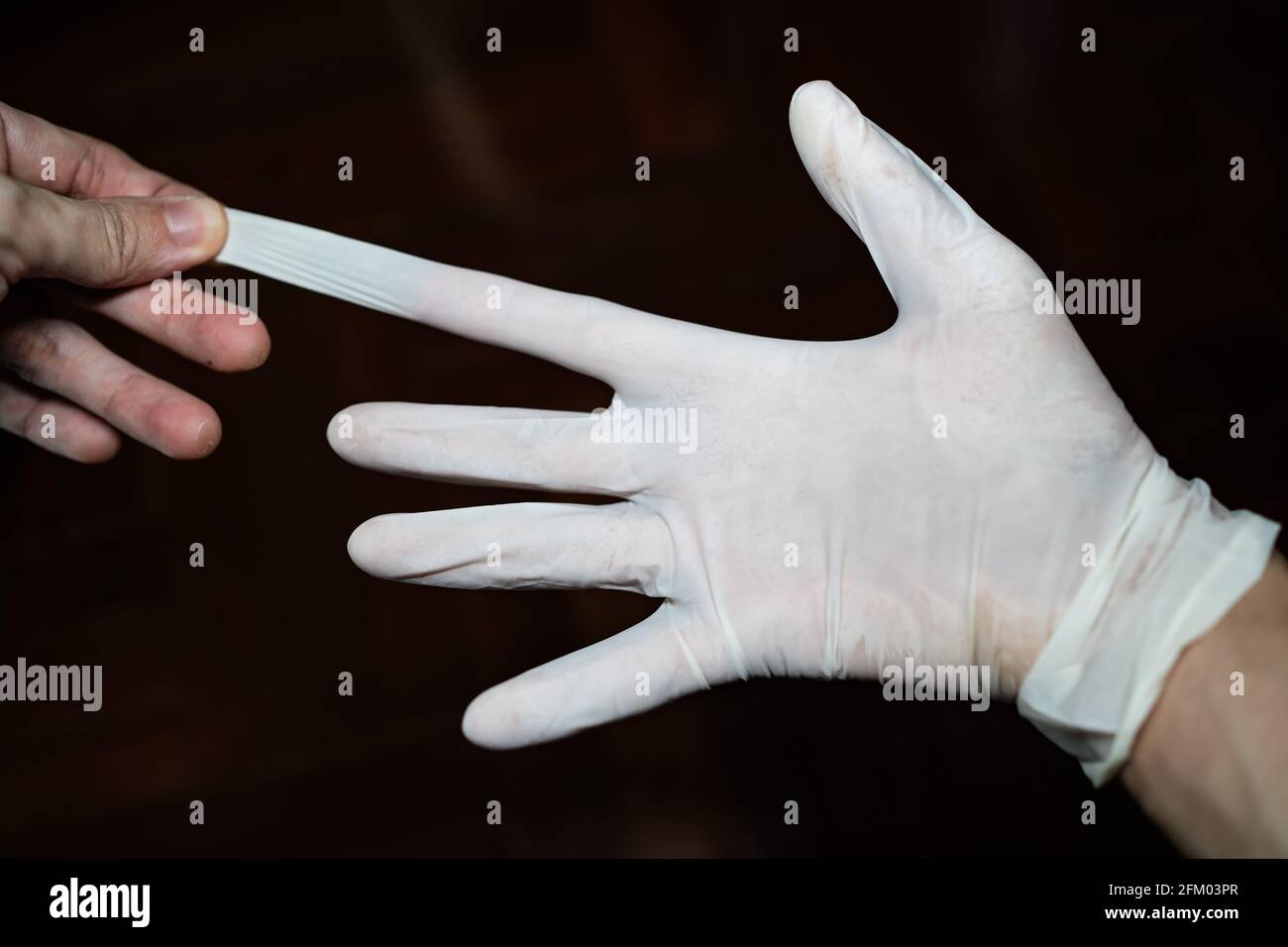 stretching the latex glove on right hand Stock Photo