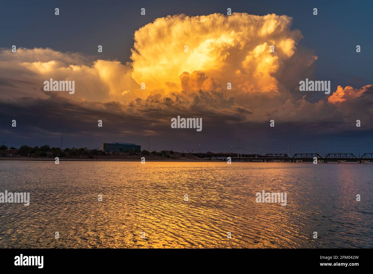 Beautiful sunset thunderstorm reflecting on a lake Stock Photo