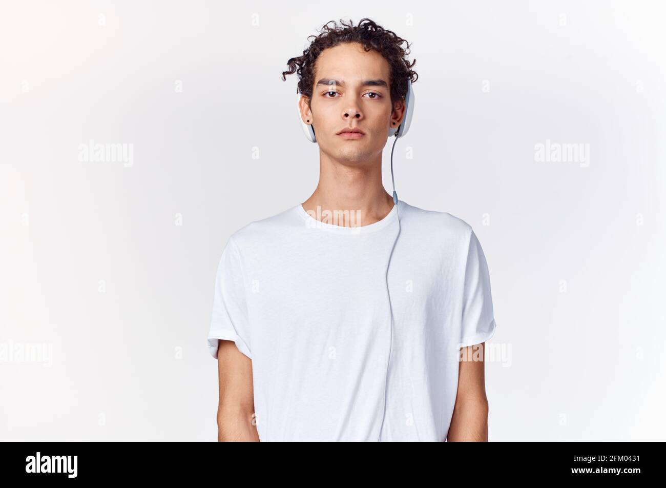 teenage boy in a t-shirt listening to 