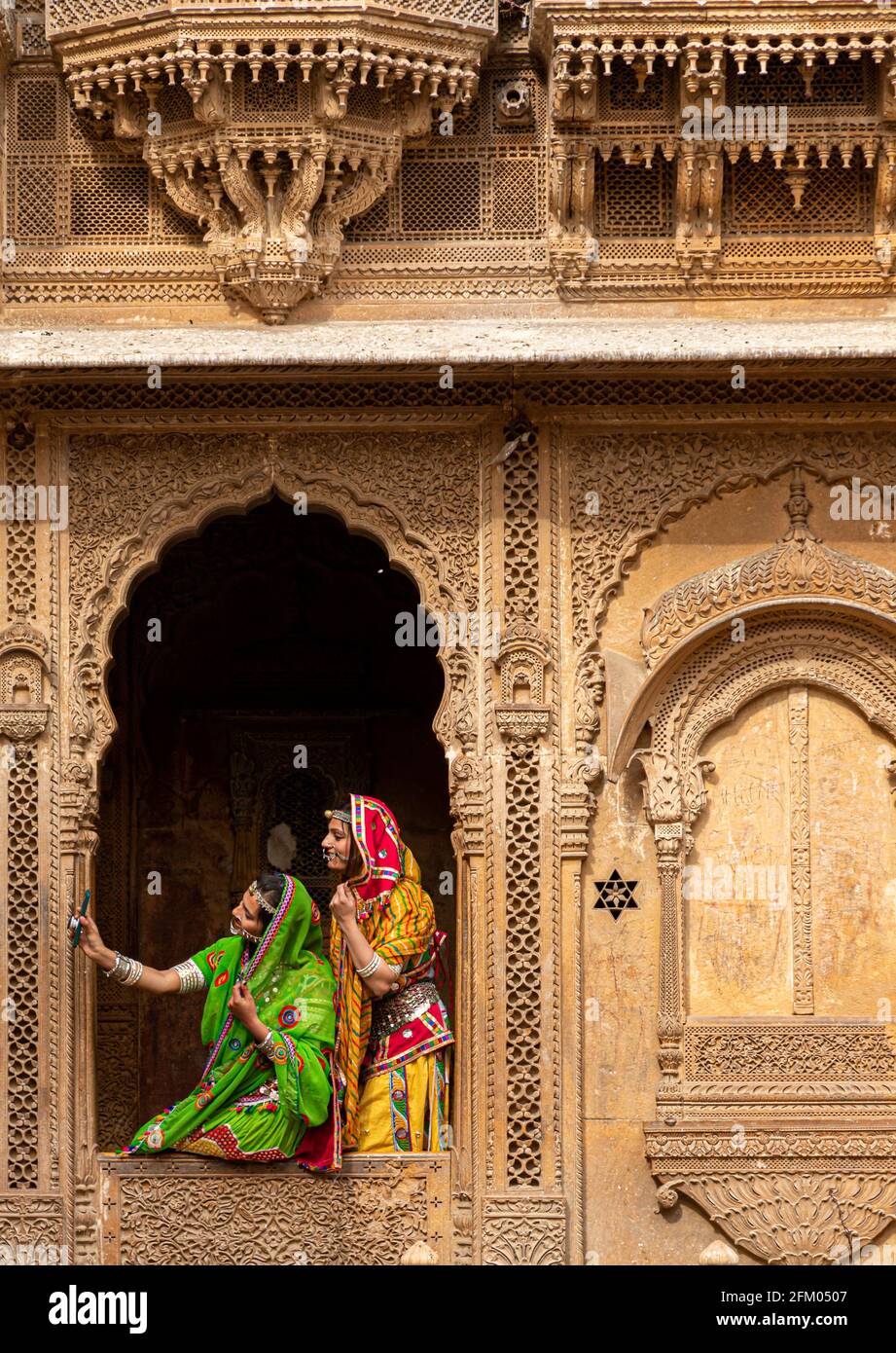indian woman dressed in traditional rajasthani outfit at patwon ki haveli at jaisalmer,rajasthan. Stock Photo