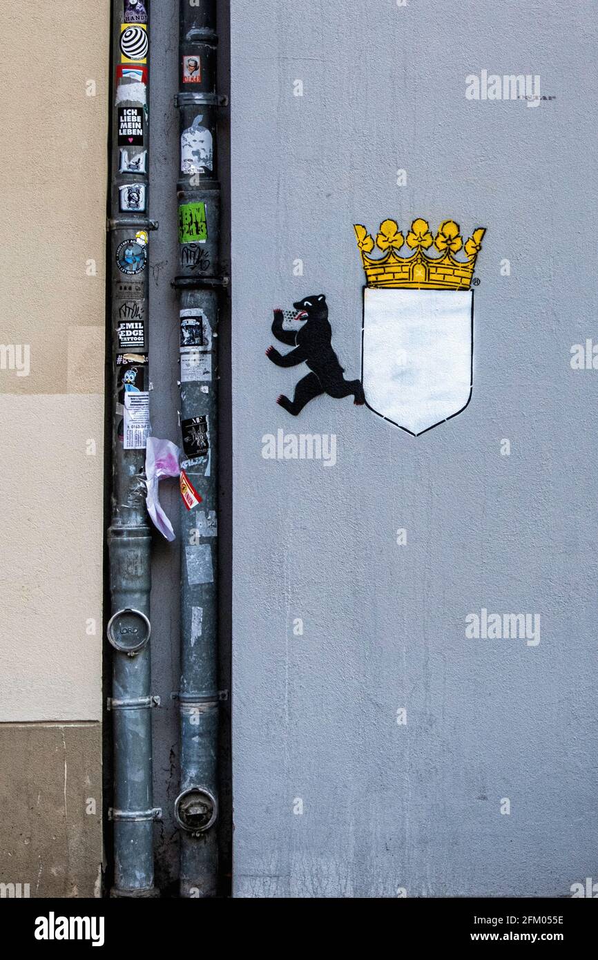 Sticker covered drain pipes and berlin bear emblem on wall in Prenzlauer Berg, Berlin, Germany Stock Photo