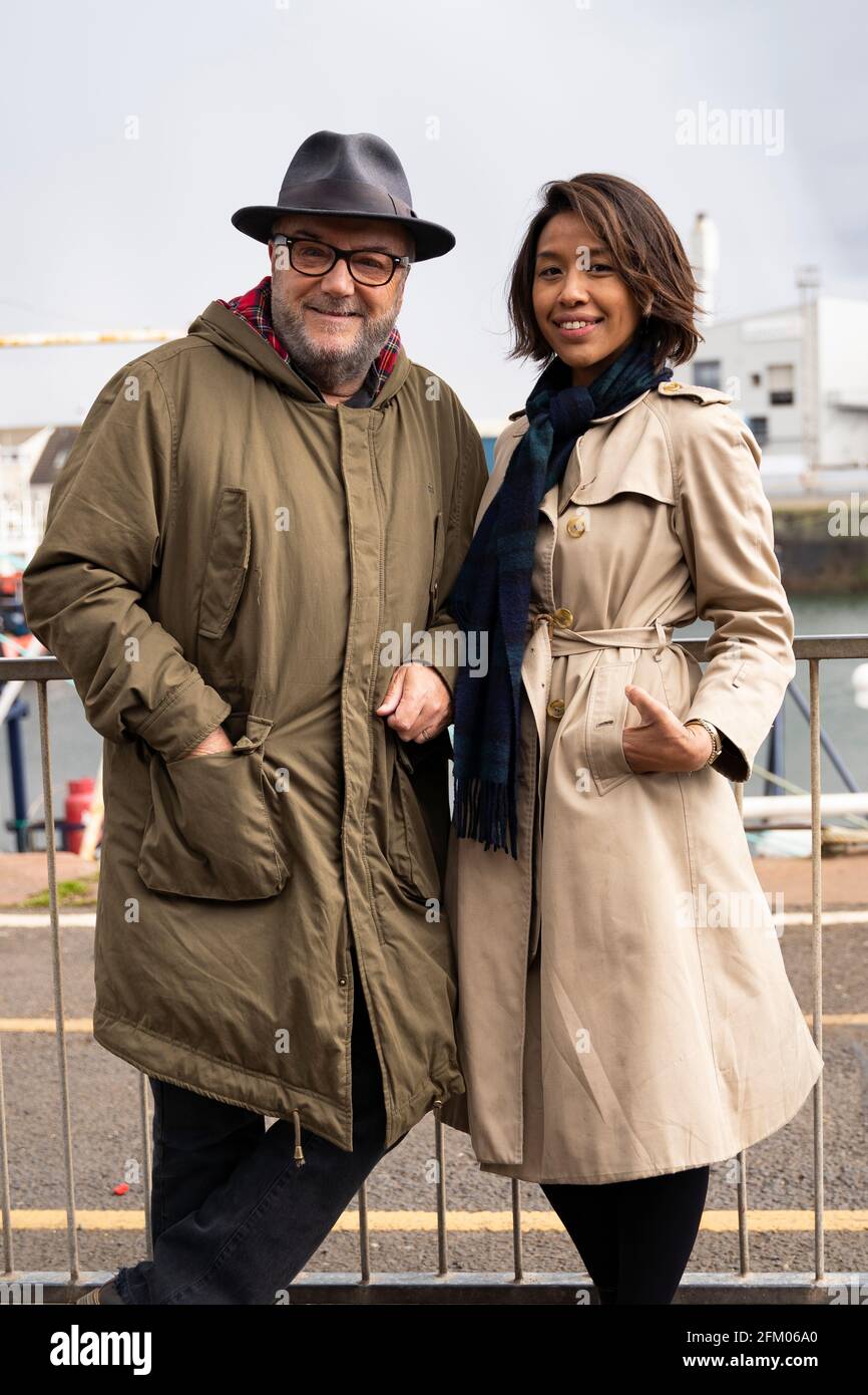 Founder of  pro Union All for Unity party George Galloway campaigns on the beach promenade in Troon Pic; With his wife Putri Gayatri Pertiwi Stock Photo