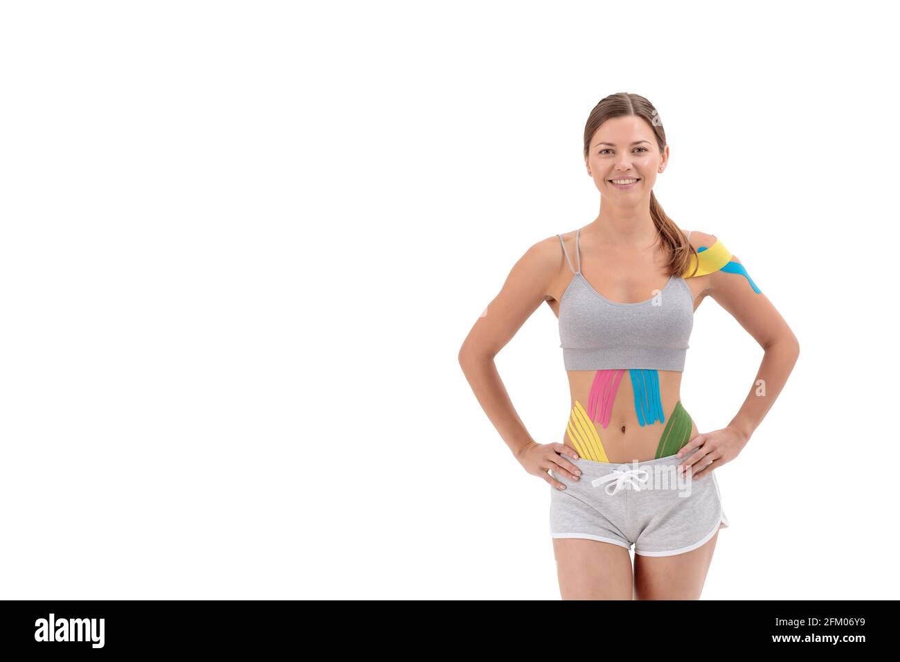 Kinesiology taping. Young female athlete isolated on white background