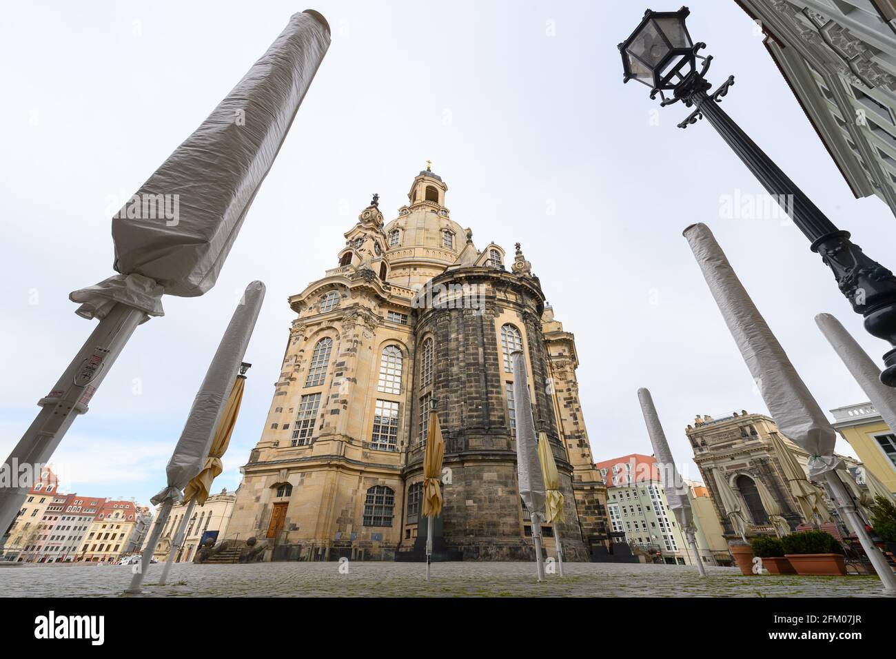 Dresden, Germany. 05th May, 2021. Sunshades of a restaurant are folded up and covered with protective hoods on the Neumarkt in front of the Frauenkirche. Credit: Robert Michael/dpa-Zentralbild/dpa/Alamy Live News Stock Photo