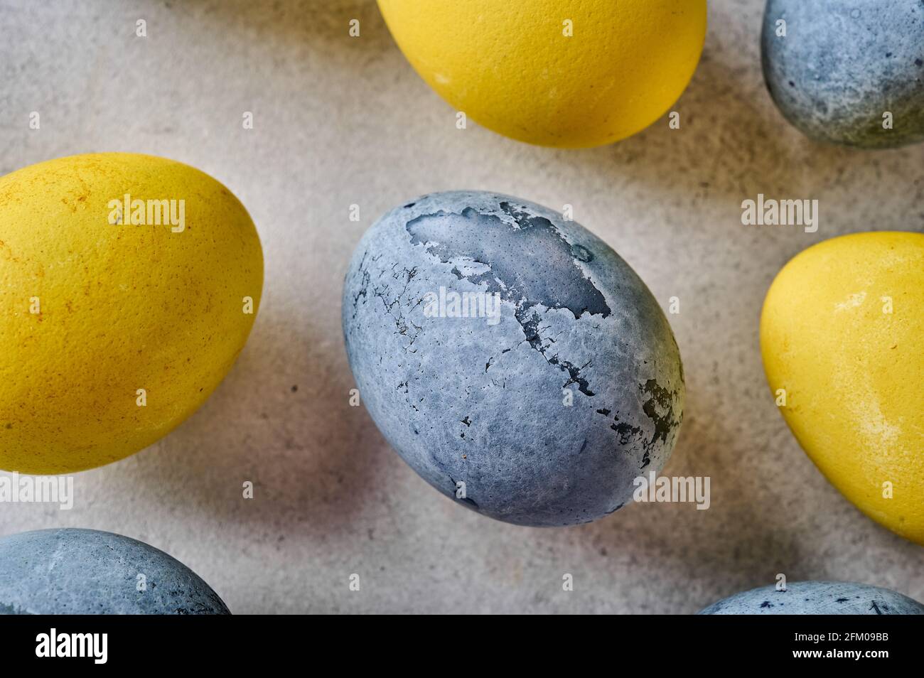 Homemade Easter colored yellow and grey marble eggs. Close up ...