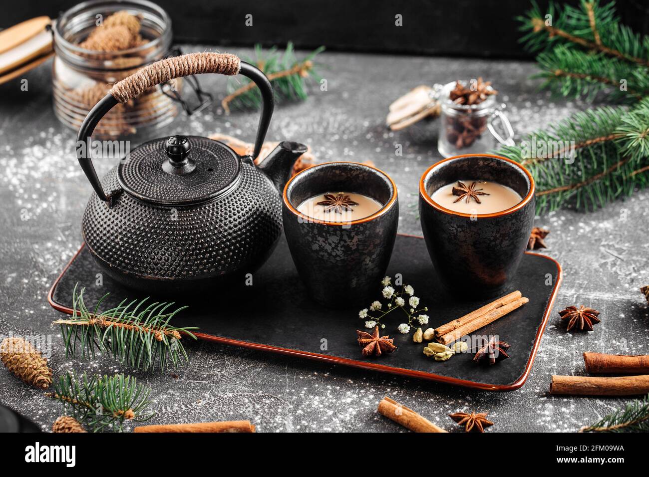 Castiron teapot and cups on decorated background Stock Photo Alamy