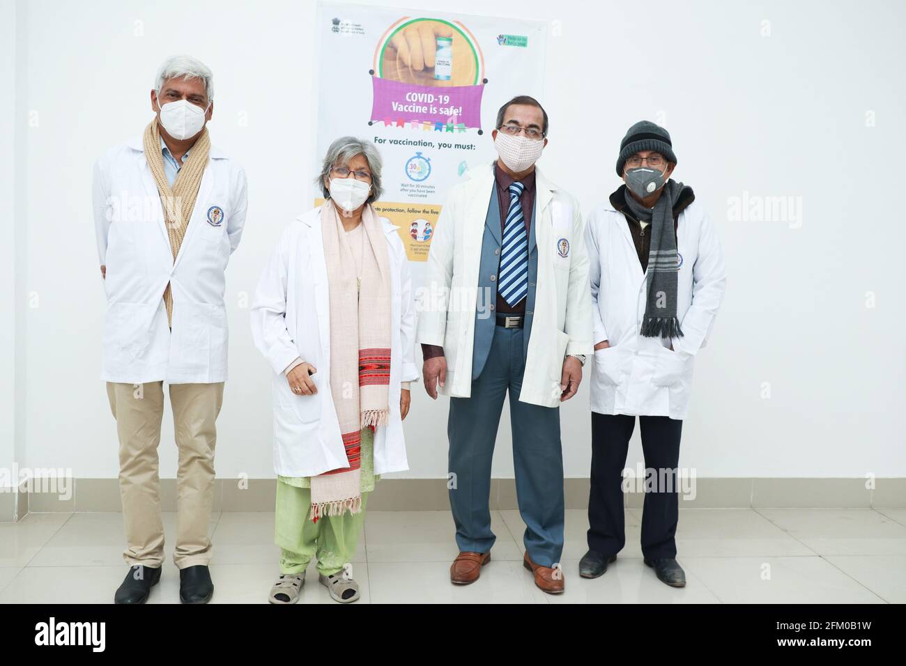 January 2021, Kishanganj, india. A team of Senior doctors standing near a wall poster of Covid 19 Vaccination in the premises of MGM Medical College K Stock Photo