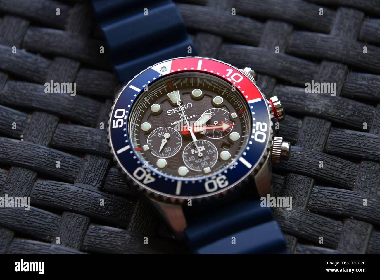Closeup of a Seiko solar diver chronograph wrist watch on silicon band on a  weaved garden table Stock Photo - Alamy