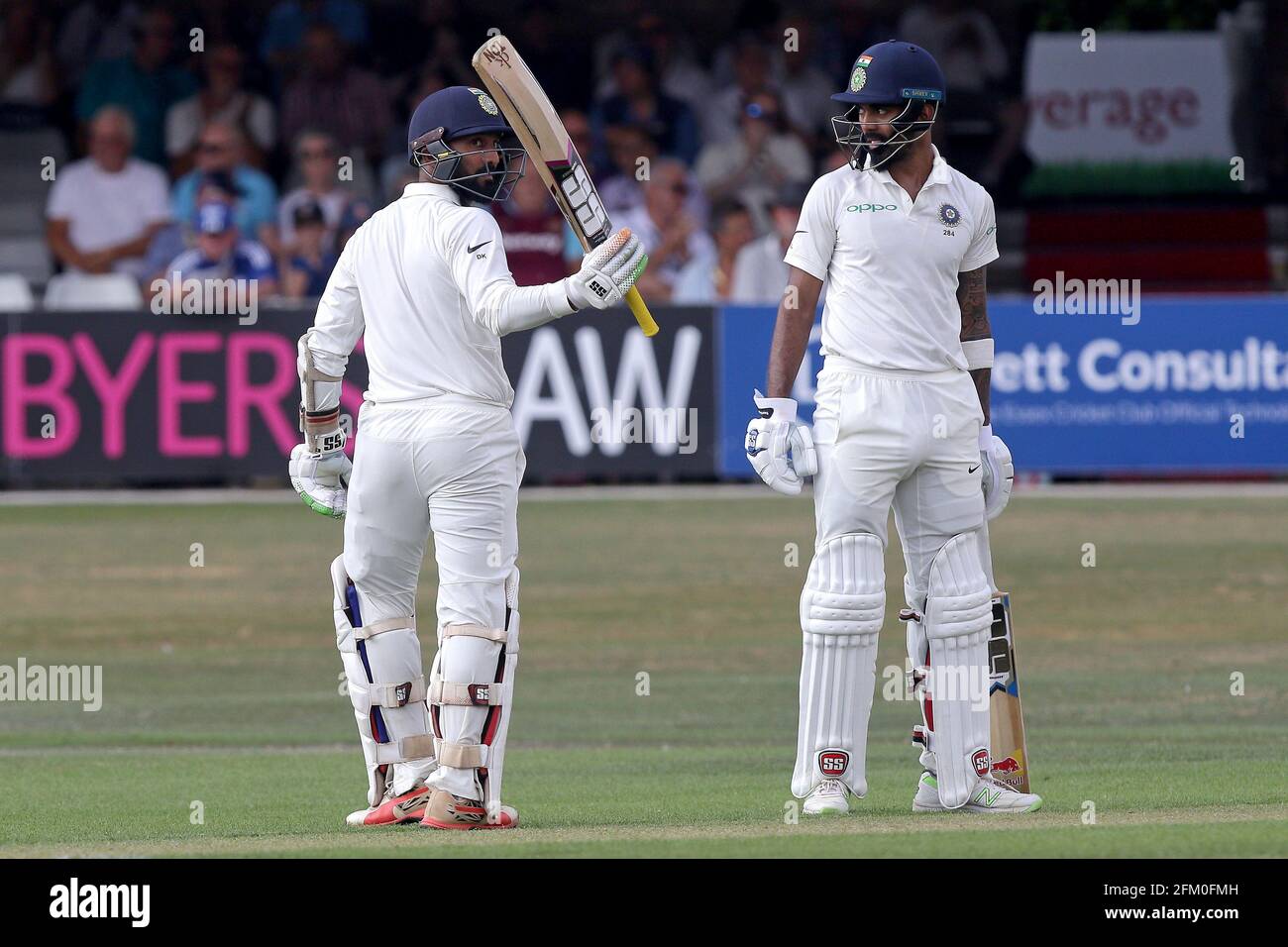 Dinesh Karthik of India raises his bat to celebrate reaching his fifty ...