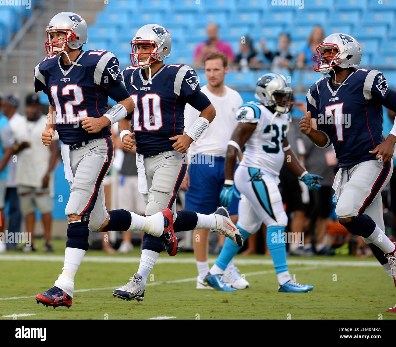 Charlotte, USA. 26th Aug, 2016. New England Patriots quarterback Tom Brady, left, leads quarterbacks Jimmy Garoppolo, center and Jacoby Brissett, right, onto the field at Bank of America Stadium for a pre-game warmup on Friday, August 26, 2016. (Photo by Jeff Siner/The Charlotte Observer/TNS/Sipa USA) Credit: Sipa USA/Alamy Live News Stock Photo