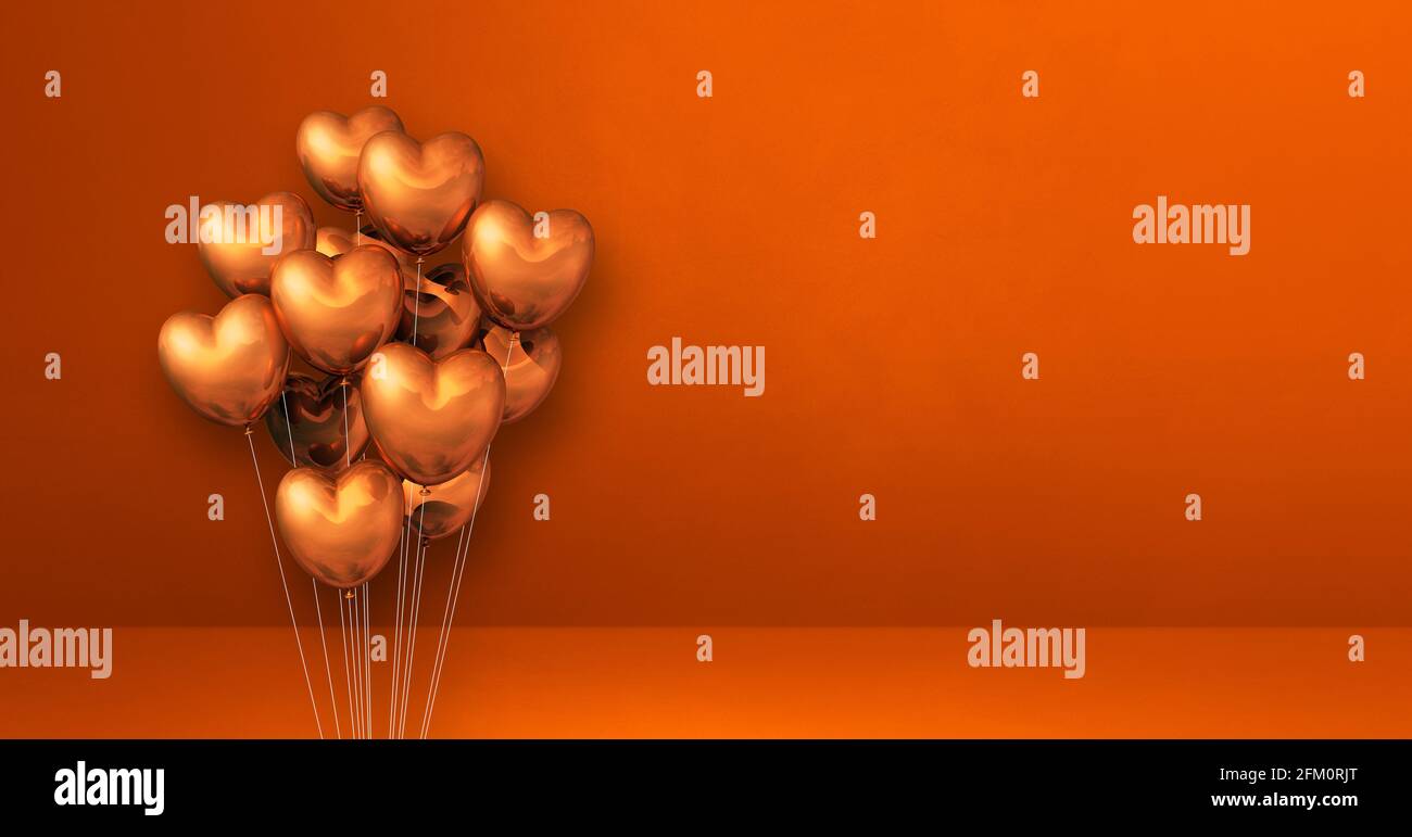 Copper heart shape balloons bunch on orange wall background. Horizontal ...