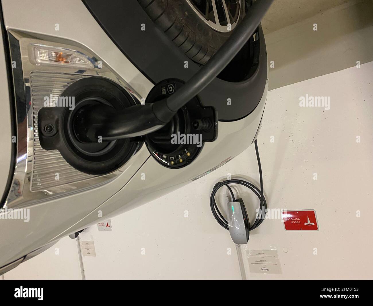 Munich, Germany. 05th May, 2021. Wallbox for charging an e-car, electric  car, e-car is charged in a parking garage, charging plug, charging cable,  box, charger hangs on the wall, charging column, charging