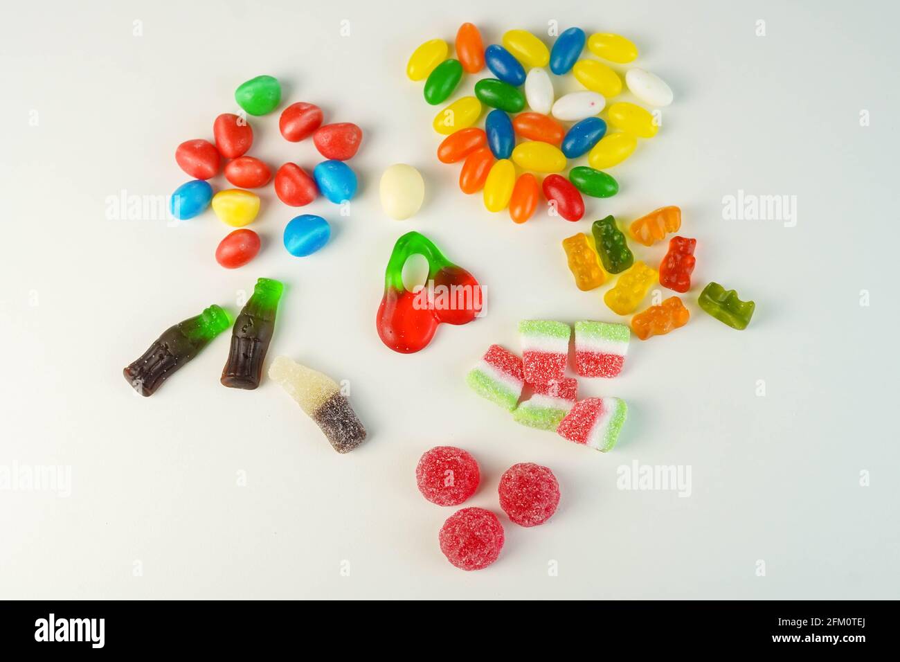 Many sweets and candies on a white background. Too much sugar concept ...