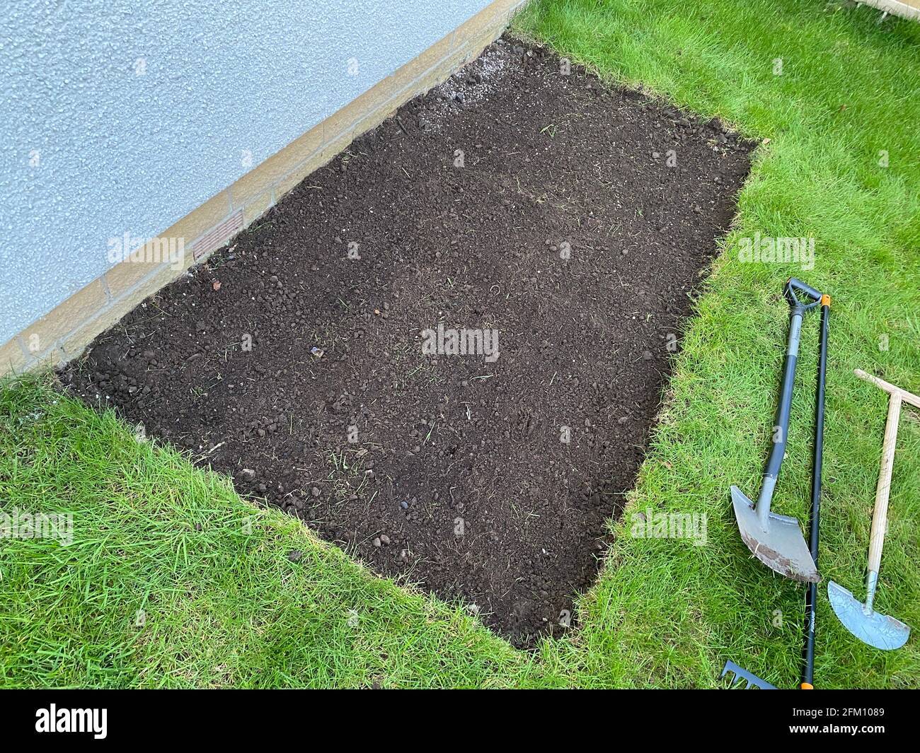 House garden grass turf cut for ground preparation to allow stone sub base to be laid Stock