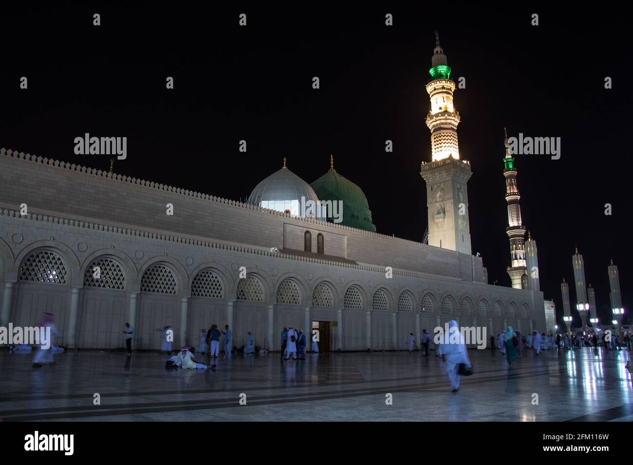 Masjid Nabawi at night time. People walking at night at the Prophet's Mosque in Medina Stock Photo