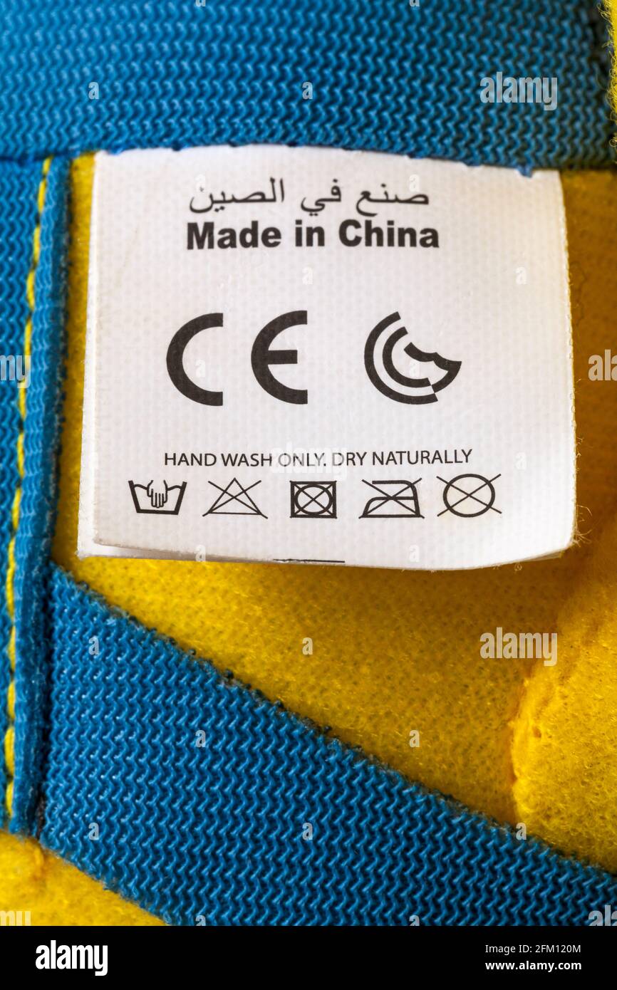 CE mark marking logo symbol with care washing symbols and instructions on label of Minions soft cuddly toy Made in China Stock Photo