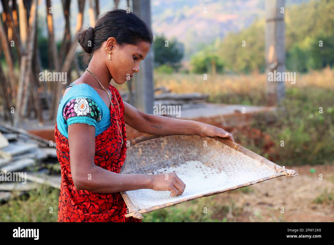 Tribal woman with Winnowing pan at Korrakothavalasa Village in Araku, Andhra Pradesh, India