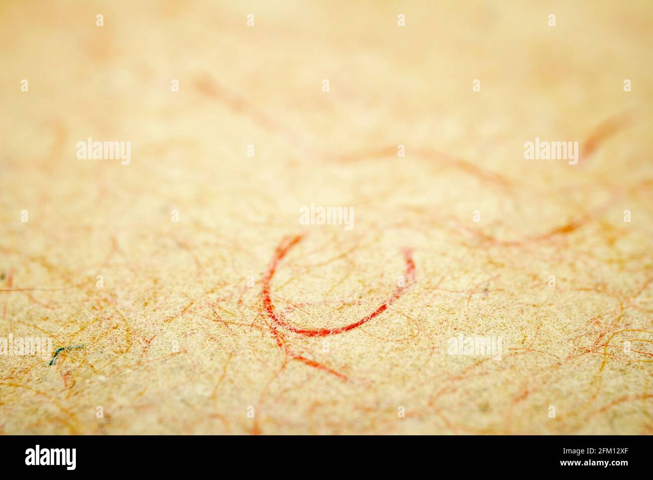 Extreme closeup of yellow handmade paper with shallow deph of field. Stock Photo