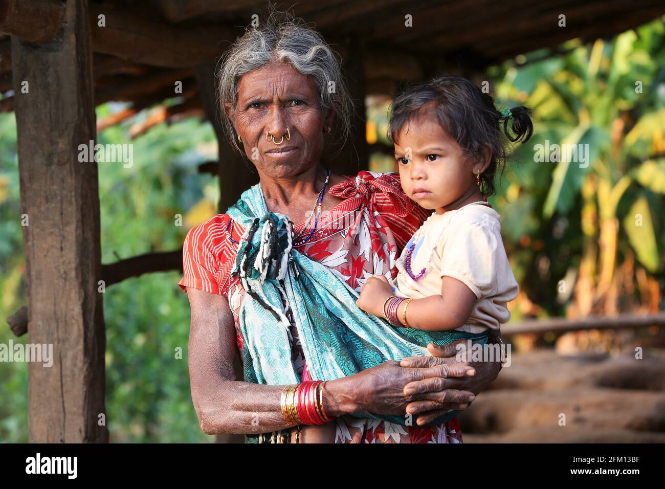 Tribal grand mother carrying her grand daughter at Korrakothavalasa village, Araku, Andhra Pradesh, India. KONDHU TRIBE Stock Photo