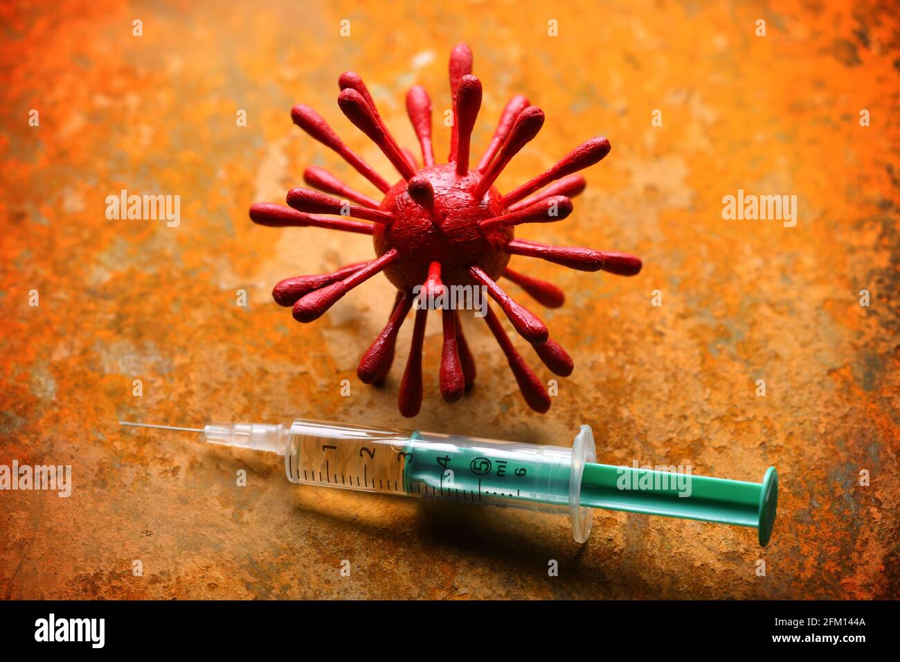 Coronavirus Model And Syringe, Covid Vaccination Stock Photo