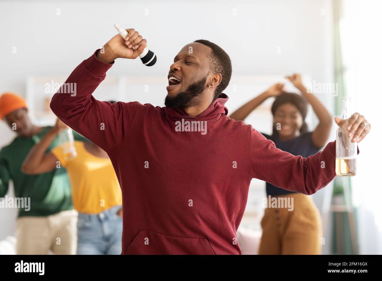 Funny black guy singing karaoke at home Stock Photo Alamy