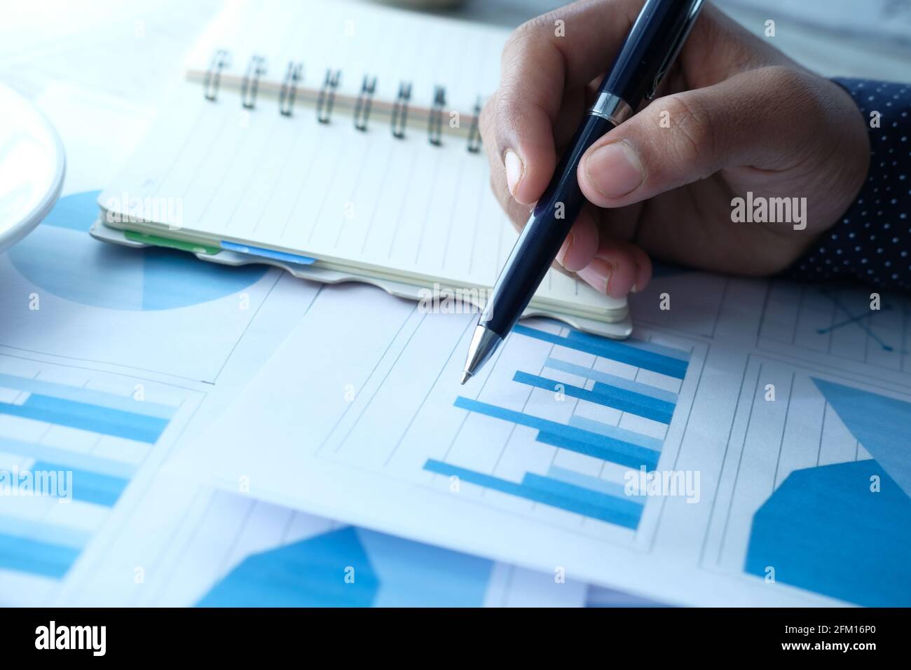 man hand with pen analyzing bar chart on paper Stock Photo - Alamy