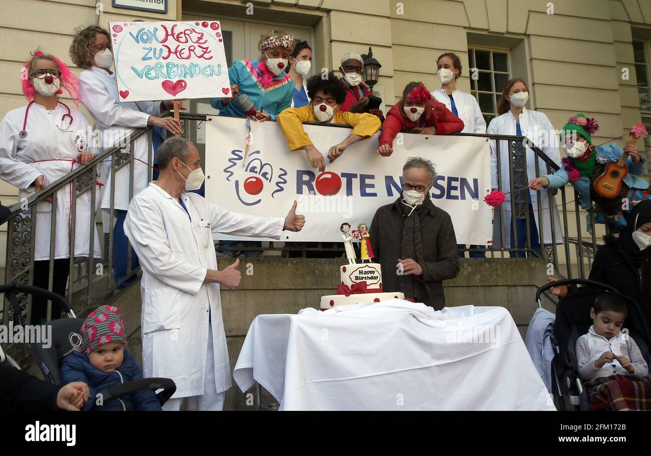 Berlin, Germany. 05th May, 2021. Felix Berger (l), Director of the Clinic for Congenital Heart Defects, takes part in the anniversary clown parade at the German Heart Centre (DHZ) in the Moabit district. On the right is Reinhard Horstkotte, artistic director of the Red Noses. For 15 years, the clinic clowns of 'Red Noses' have been bringing laughter and lightness to children with heart disease. Credit: Wolfgang Kumm/dpa/Alamy Live News Stock Photo