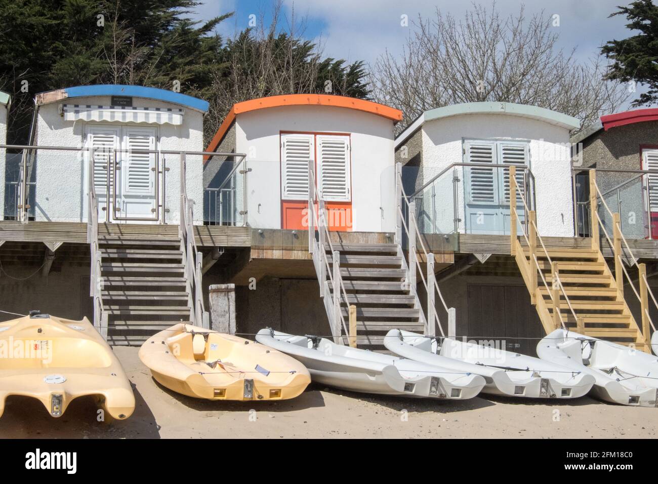 Abersoch Beach in April,out of season,empty beach,beaches,and,closed,beach huts,Abersoch,Llyn Peninsula,Gwynedd,North Wales,Wales,Welsh,Europe.  In Abersoch, a coastal village on the Llŷn Peninsula, about 39% of homes are second homes.Welsh village dubbed 'Cheshire-by-the-Sea' because number of holiday homes snapped up by wealthy owners.families have been priced out by people snapping up coastal properties for second homes Stock Photo