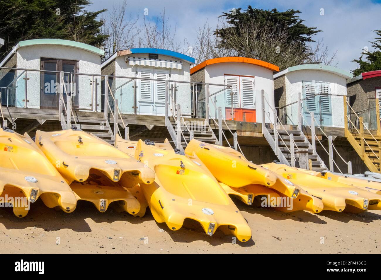 Abersoch Beach in April,out of season,empty beach,beaches,and,closed,beach huts,Abersoch,Llyn Peninsula,Gwynedd,North Wales,Wales,Welsh,Europe.  In Abersoch, a coastal village on the Llŷn Peninsula, about 39% of homes are second homes.Welsh village dubbed 'Cheshire-by-the-Sea' because number of holiday homes snapped up by wealthy owners.families have been priced out by people snapping up coastal properties for second homes Stock Photo