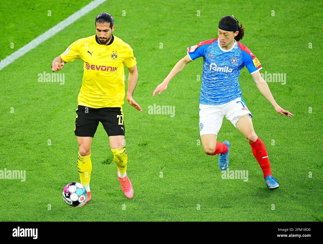 left to right Emre CAN (DO) versus Jae Sung LEE (KI), action, duels, football DFB Pokal, semi-finals, Borussia Dortmund (DO) - Holstein Kiel (KI) 5: 0, on May 1st, 2021 in Dortmund/Germany. Photo: TimGroothuis/Witters/pool via Fotoagentur SVEN SIMON # DFB regulations prohibit any use of photographs as image sequences and/or quasi-video # Editorial Use ONLY # National and International News Agencies OUT | usage worldwide Stock Photo