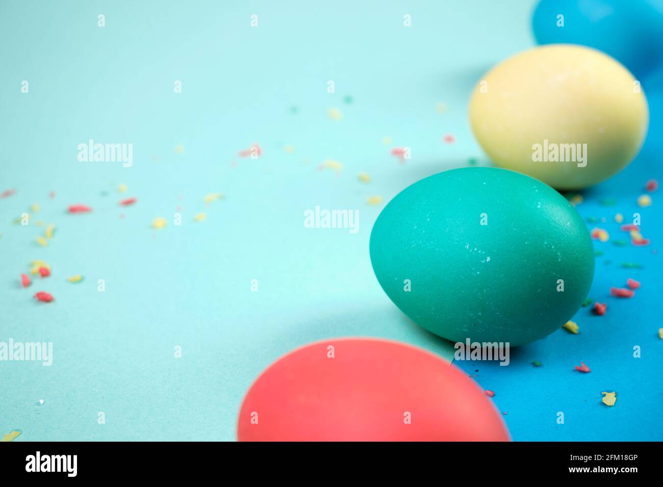 Colored chicken eggs. Easter holiday. Abstraction. Place for text. Stock Photo