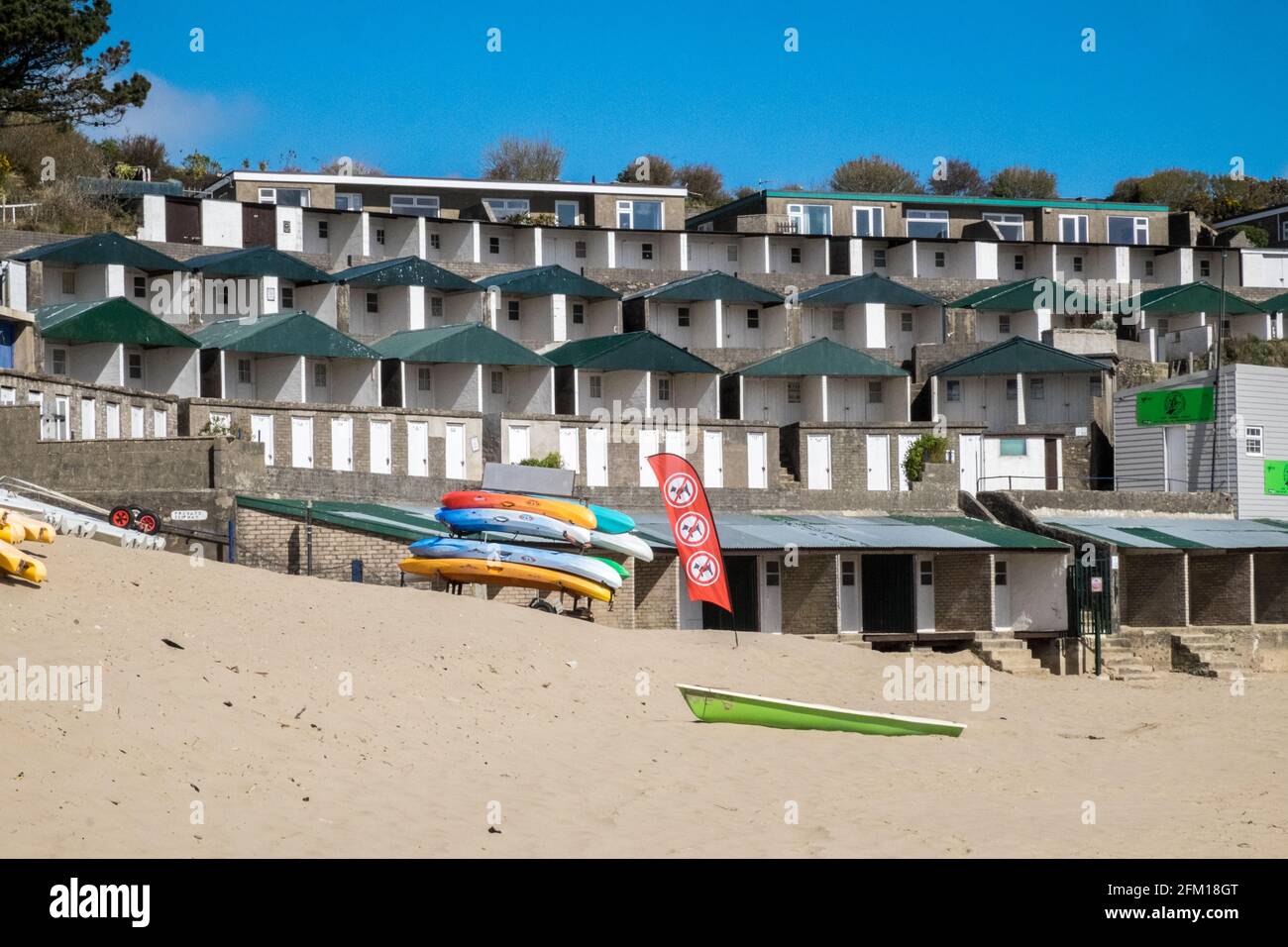 Abersoch Beach in April,out of season,empty beach,beaches,and,closed,beach huts,Abersoch,Llyn Peninsula,Gwynedd,North Wales,Wales,Welsh,Europe.  In Abersoch, a coastal village on the Llŷn Peninsula, about 39% of homes are second homes.Welsh village dubbed 'Cheshire-by-the-Sea' because number of holiday homes snapped up by wealthy owners.families have been priced out by people snapping up coastal properties for second homes Stock Photo