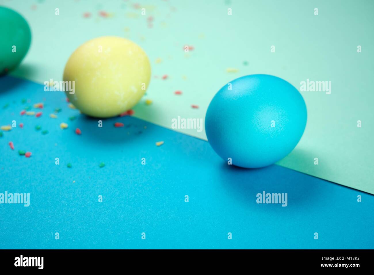 Colored chicken eggs. Easter holiday. Abstraction. Place for text. Stock Photo