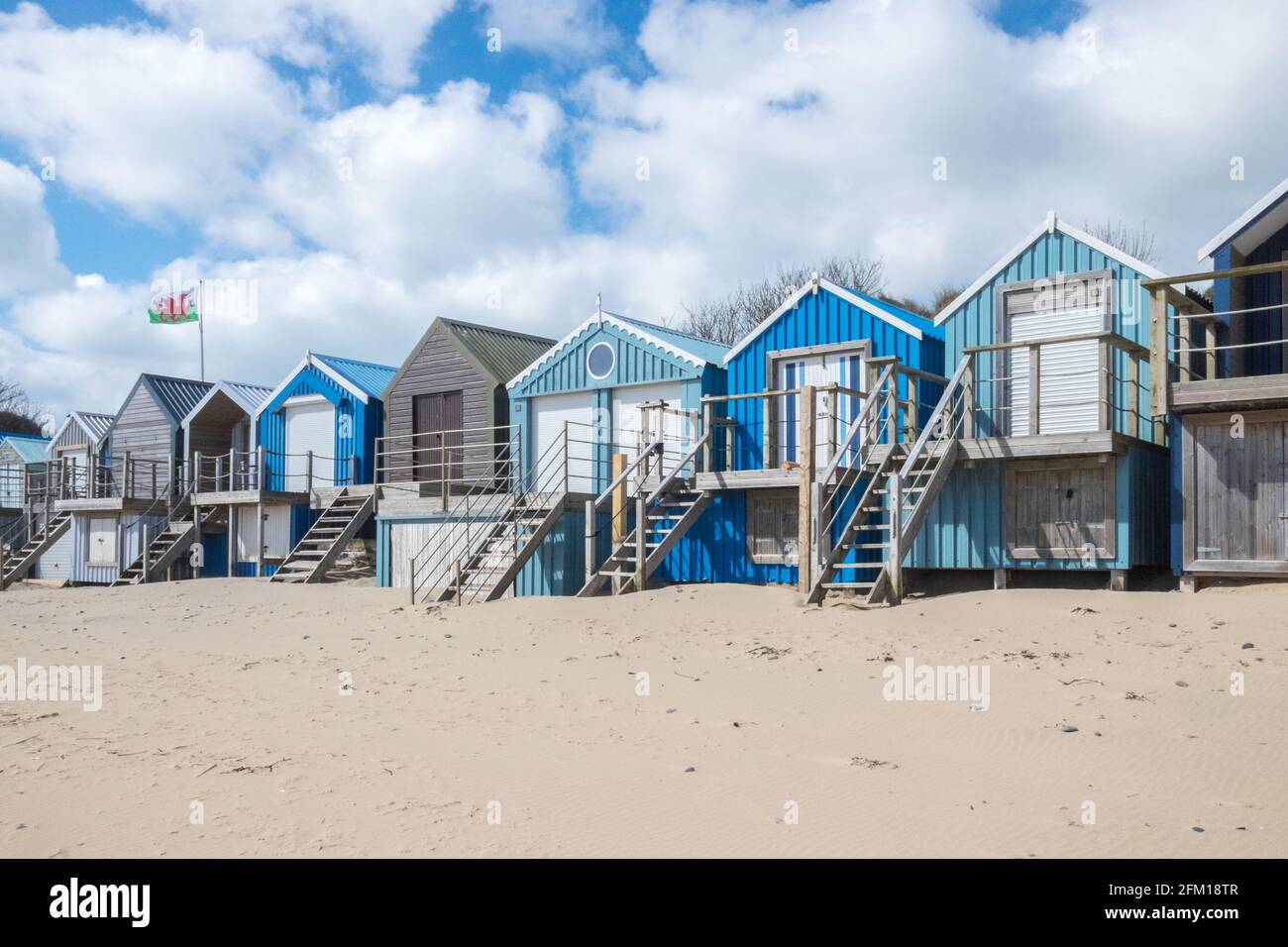 Abersoch Beach in April,out of season,empty beach,beaches,and,closed,beach huts,Abersoch,Llyn Peninsula,Gwynedd,North Wales,Wales,Welsh,Europe.  In Abersoch, a coastal village on the Llŷn Peninsula, about 39% of homes are second homes.Welsh village dubbed 'Cheshire-by-the-Sea' because number of holiday homes snapped up by wealthy owners.families have been priced out by people snapping up coastal properties for second homes Stock Photo