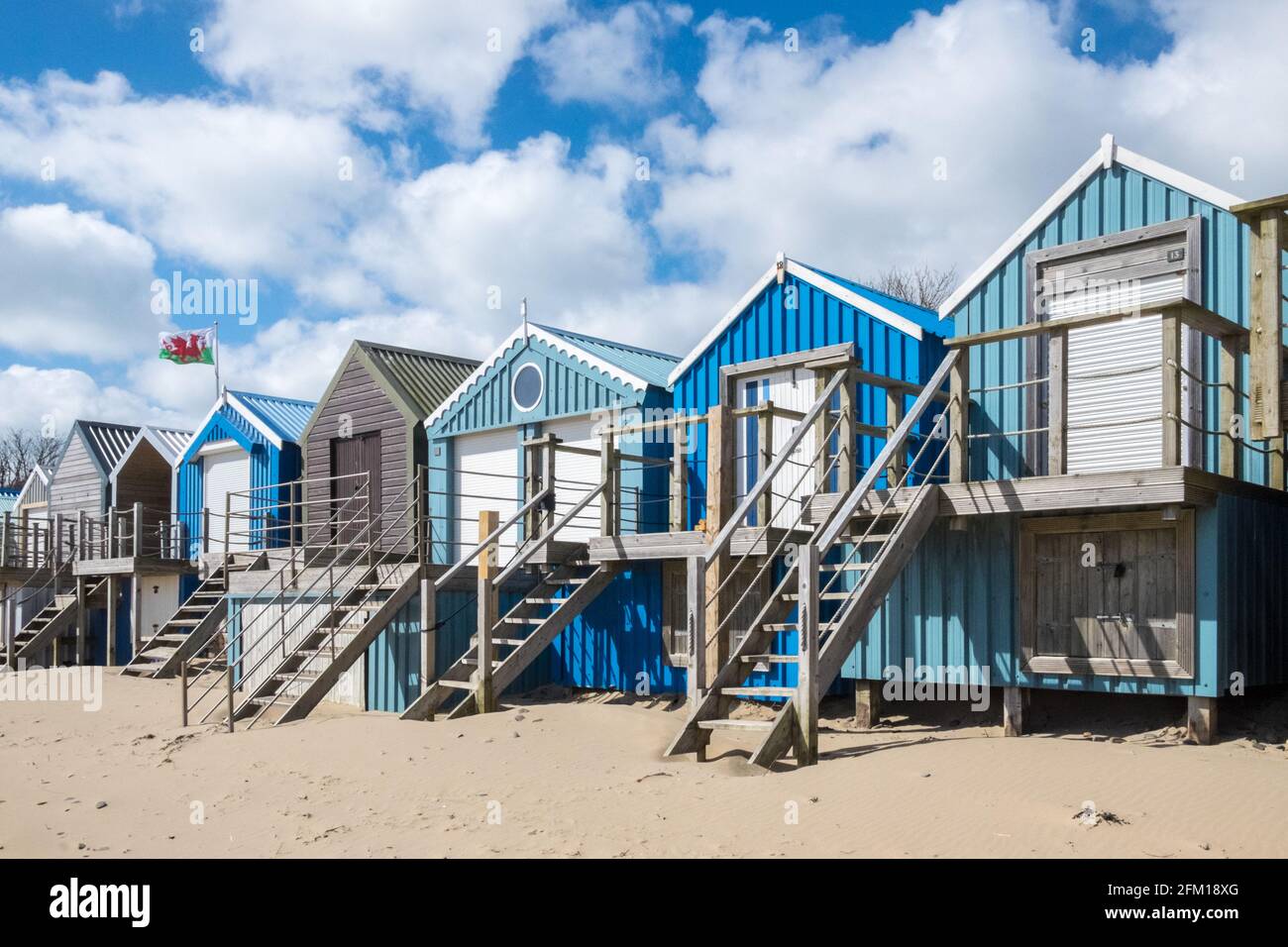 Abersoch Beach in April,out of season,empty beach,beaches,and,closed,beach huts,Abersoch,Llyn Peninsula,Gwynedd,North Wales,Wales,Welsh,Europe.  In Abersoch, a coastal village on the Llŷn Peninsula, about 39% of homes are second homes.Welsh village dubbed 'Cheshire-by-the-Sea' because number of holiday homes snapped up by wealthy owners.families have been priced out by people snapping up coastal properties for second homes Stock Photo