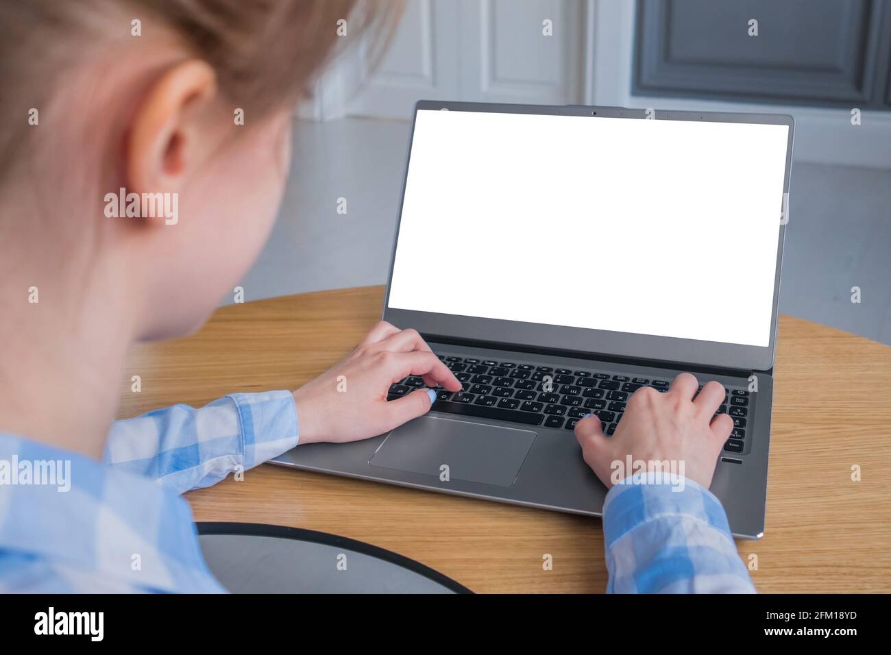 Woman student typing on grey laptop computer keyboard with white blank ...