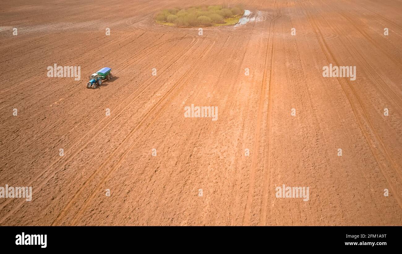 Photo from a tractor drone sowing seeds in a field. Process of planting ...