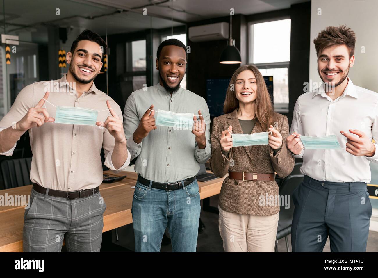 International people wearing medical masks a office Stock Photo - Alamy