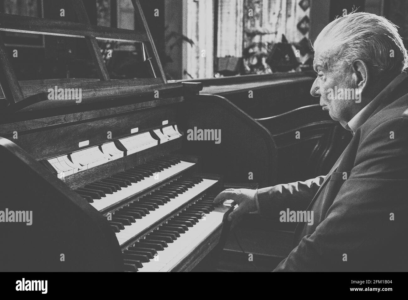 Old Man Playing the Organ in Church Stock Photo