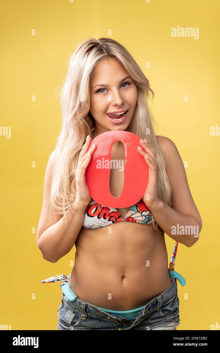 Girl holds the letters of the alphabet word love on a yellow background blonde beautiful smiles  girl caucasian beautiful, alphabet people young stude Stock Photo