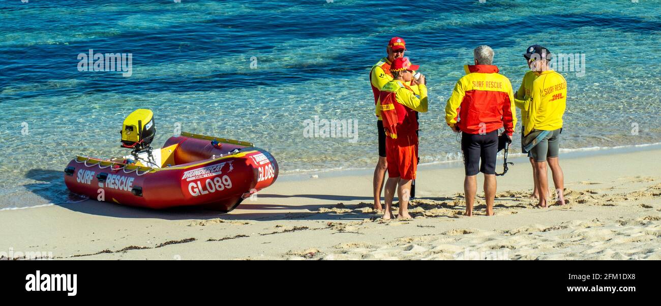 Surf lifesavers standing by an inflatable rescue boat on the shore at Gnarabup Beach Margaret River Western Australia Stock Photo