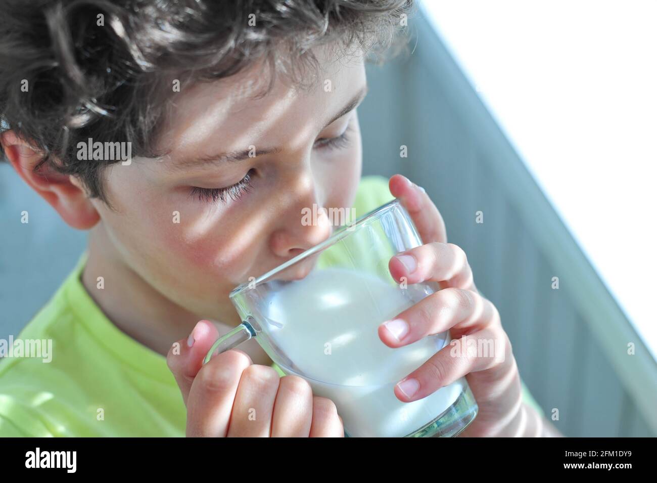 Cute little boy drinks healthy milk. Happy Milk Day! Stock Photo