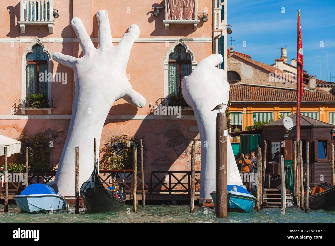 VENICE, ITALY - 07 October, 2017 Gigantic sculpture called Support for the Biennale 2017. Author - Lorenzo Quinn. The composition is dedicated to global warming Stock Photo