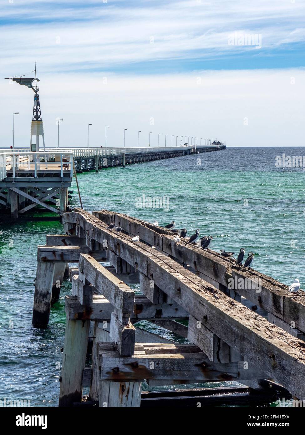 Busselton Jetty the longest timber-piled jetty in the southern hemisphere and a section of the original jetty, Western Australia Stock Photo