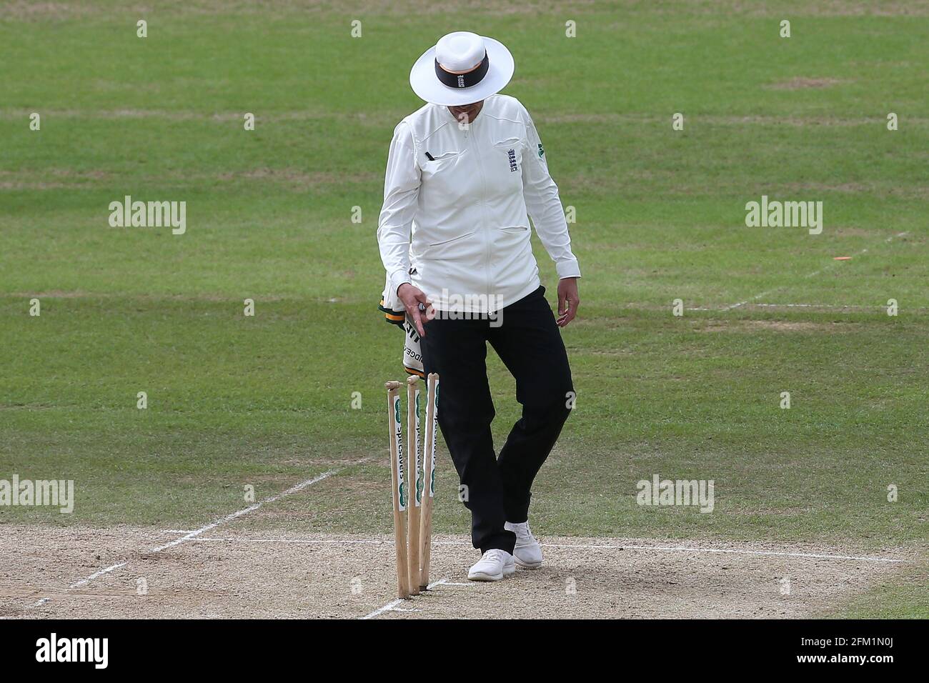 Umpire Mike Burns notices the stumps have been left at odd angles during Nottinghamshire CCC vs Essex CCC, Specsavers County Championship Division 1 C Stock Photo