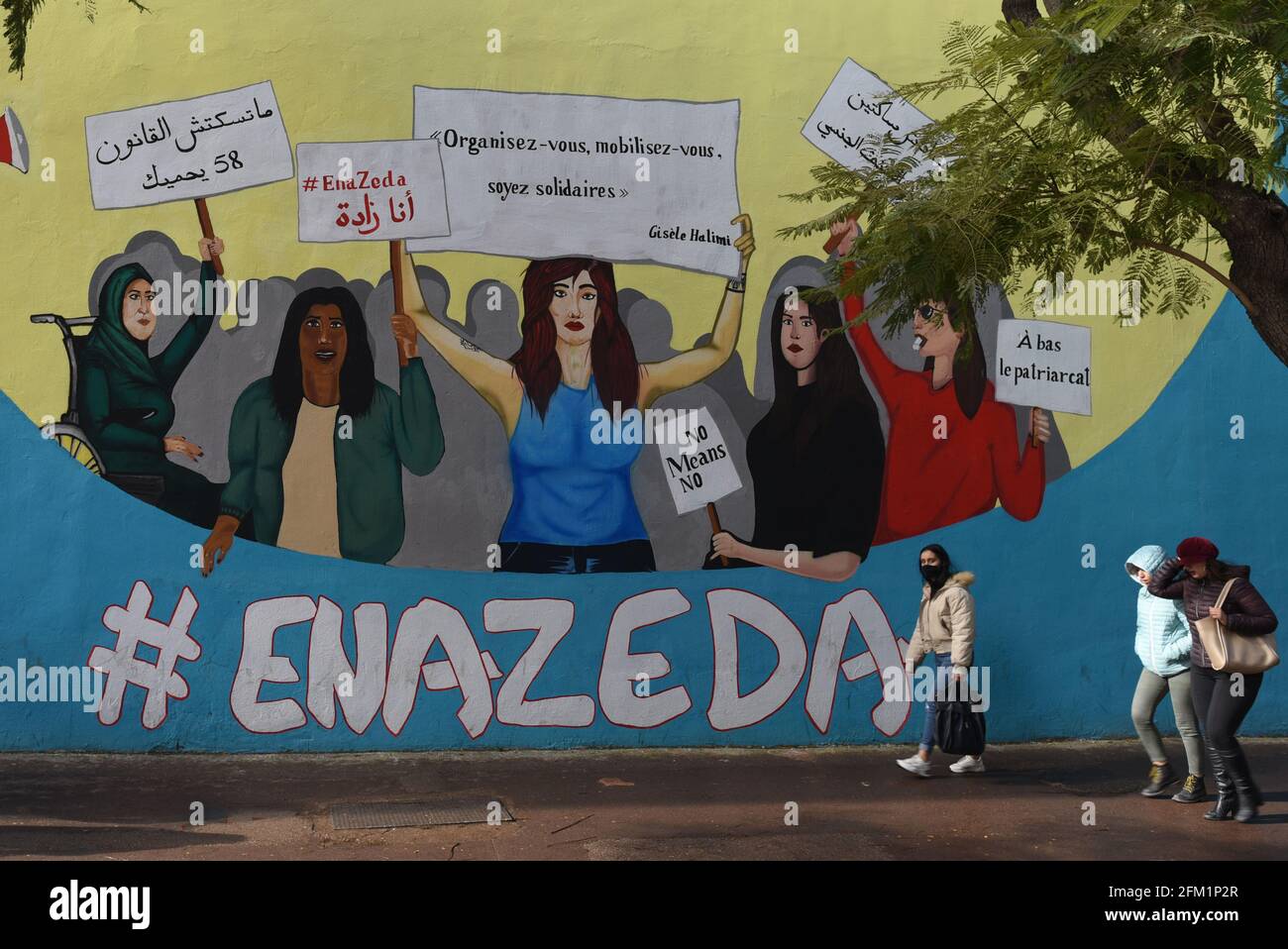 *** STRICTLY NO SALES TO FRENCH MEDIA OR PUBLISHERS - RIGHTS RESERVED ***January 12, 2021 - Tunis, Tunisia: A mural shows women protesting under the hashtag Ena Zeda, which means Me Too in Arabic, as well as slogans against sexual harassment. Freedom of expression is one of the main benefits as Tunisia prepares to mark the 10th anniversary of the 2011 revolution, which kicked off the Arab Spring. The mood acrossTunisia is gloomy as the transition to a democratic system didn't help lifting the country out of poverty. Stock Photo